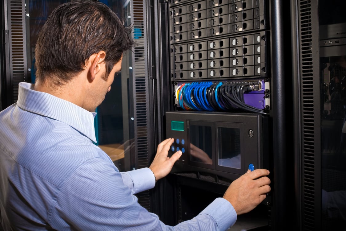 IT Technician Programming Computer Equipment in Server Room